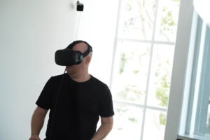 Photo of a person using an augmented reality headset | featured image for Virtual Reality.