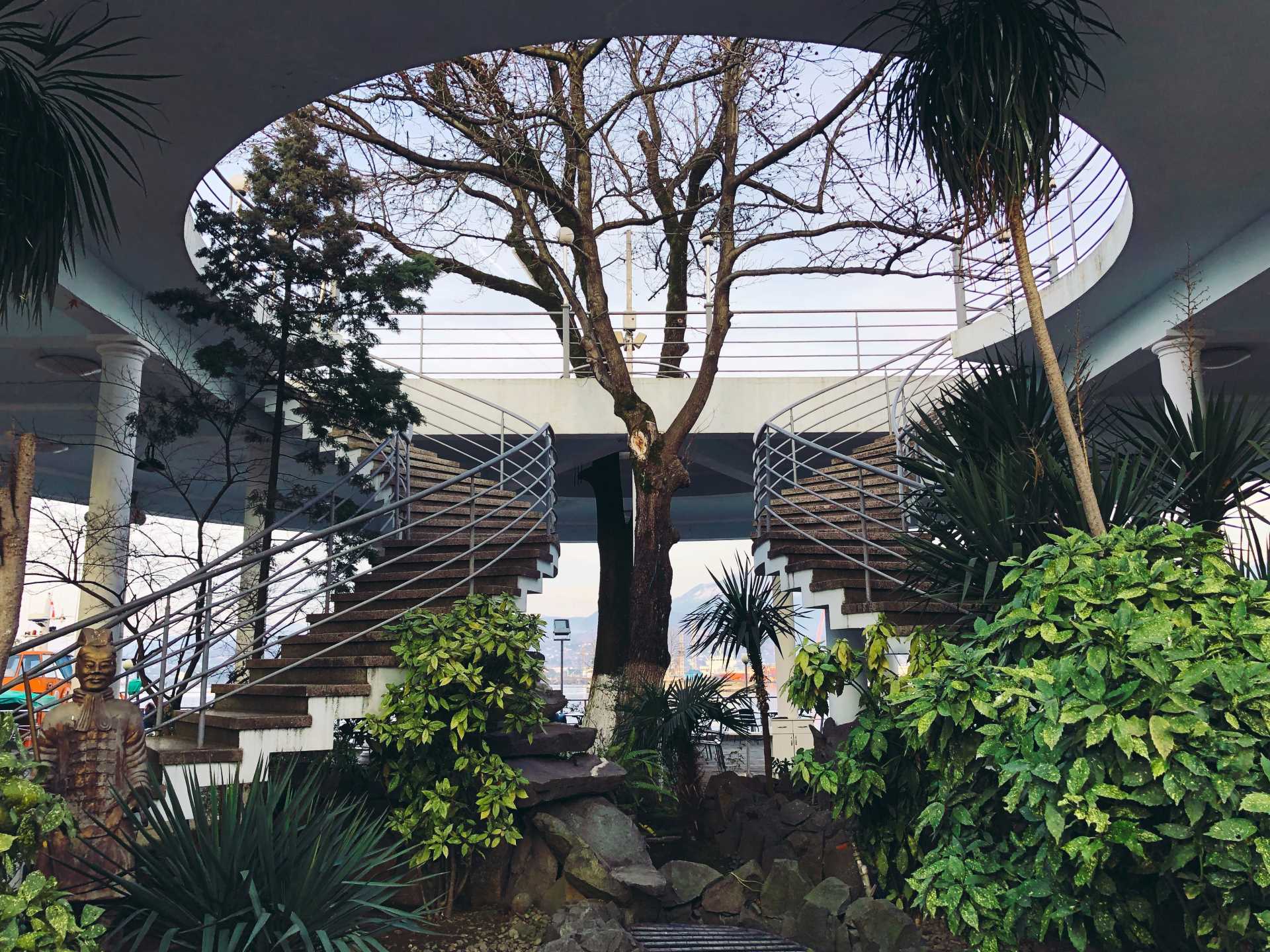 Modern building with spiral staircases and lots of plants | Featured image for the Biophilia Design – a Guide to Natural Home Design Concepts blog from Clements Clarke Architects.