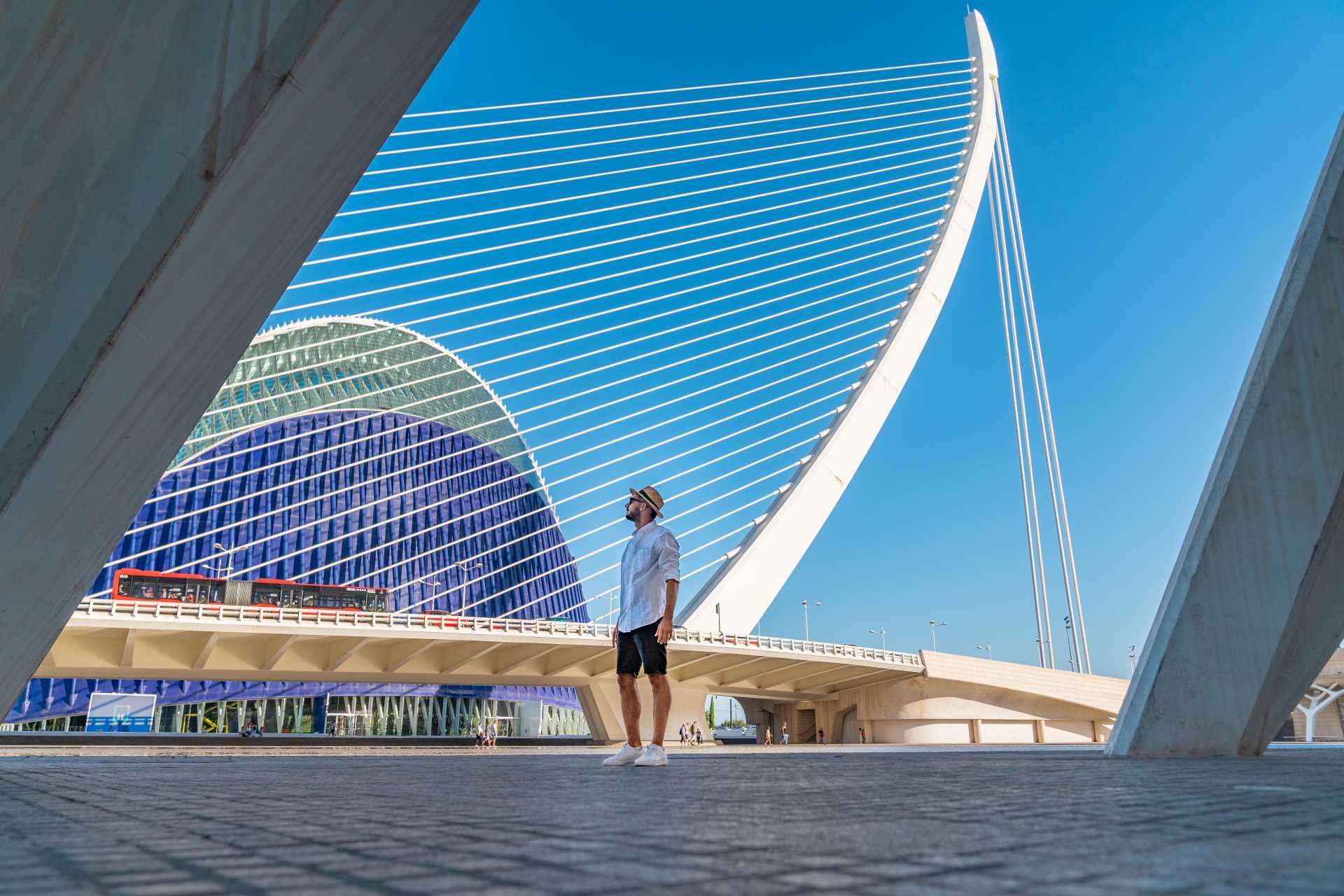Man standing in front of an artistic building and monument | Featured image for the Modern Spanish Architecture Blog by Clements Clarke Architects.